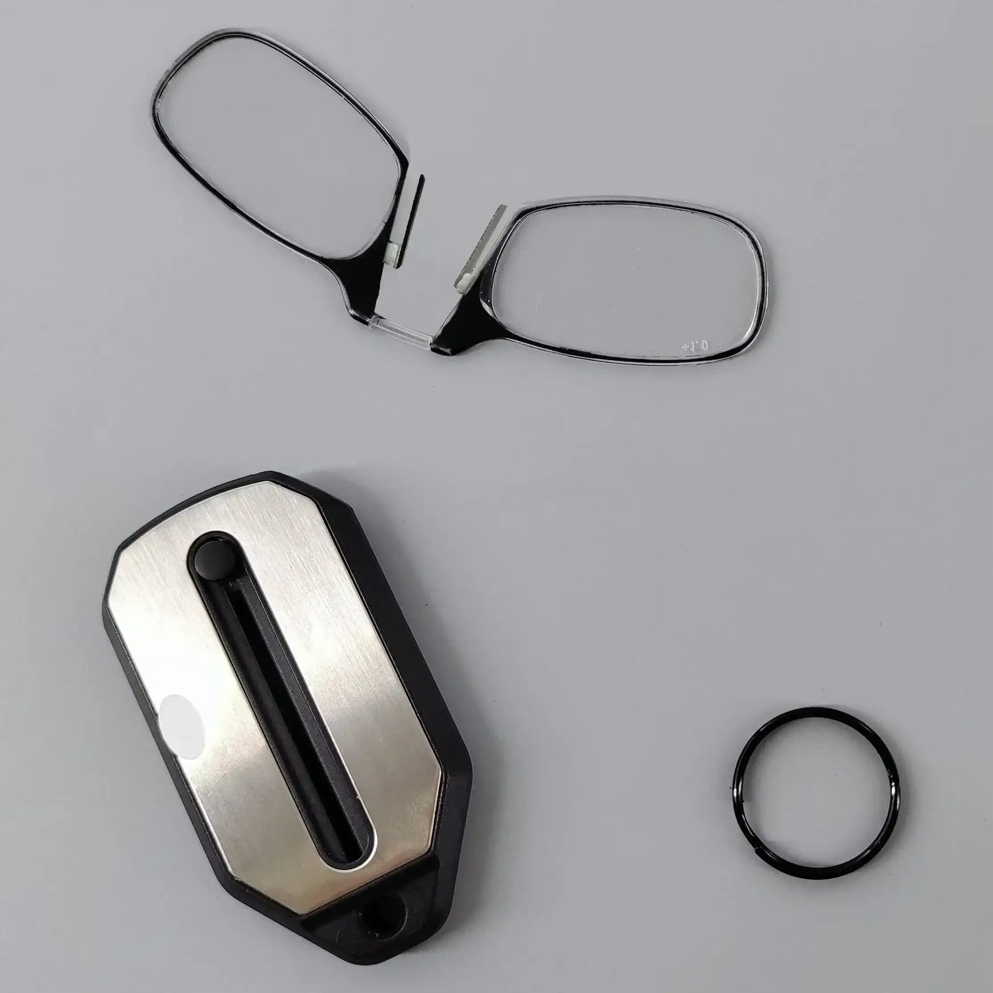 Compact folding pocket reading glasses with black frames and clear lenses, designed for convenient on-the-go reading.