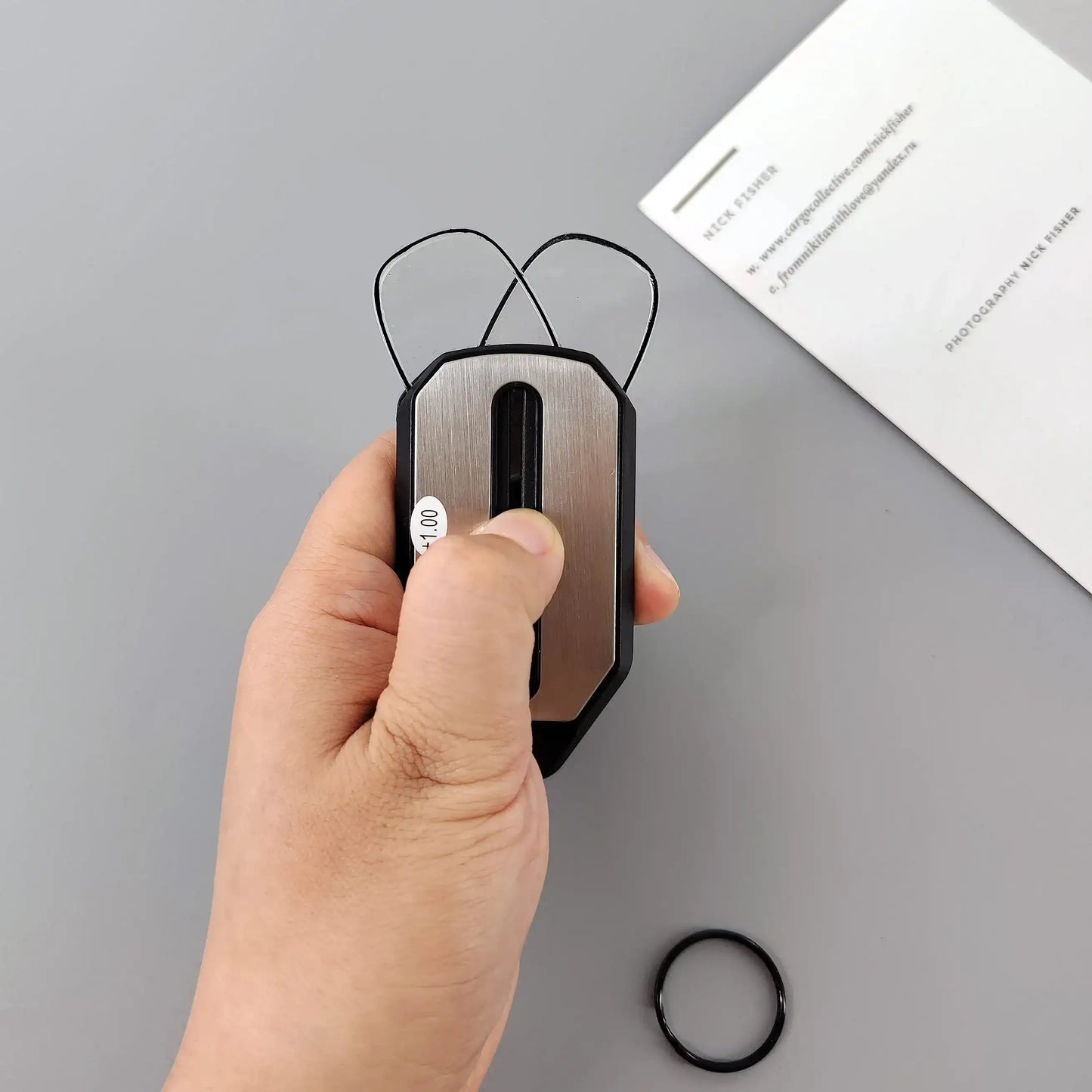 Folding pocket reading glasses with black frames and compact design, ideal for portable vision correction.