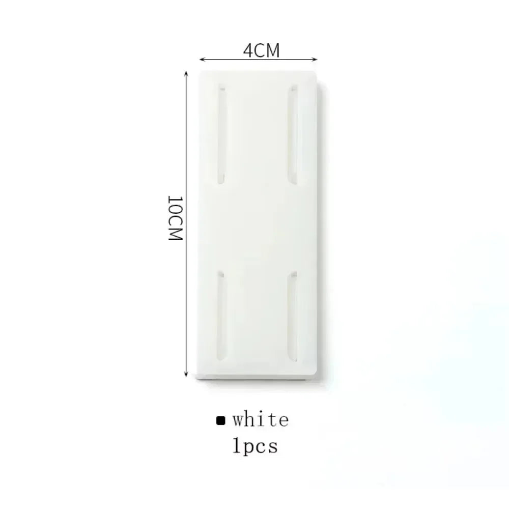 Set of 10 Smartlyo self-adhesive socket holders attached to a wall to organize and secure electrical sockets.