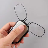 Pair of folding pocket reading glasses with black frames, compact design, ideal for portable reading assistance.
