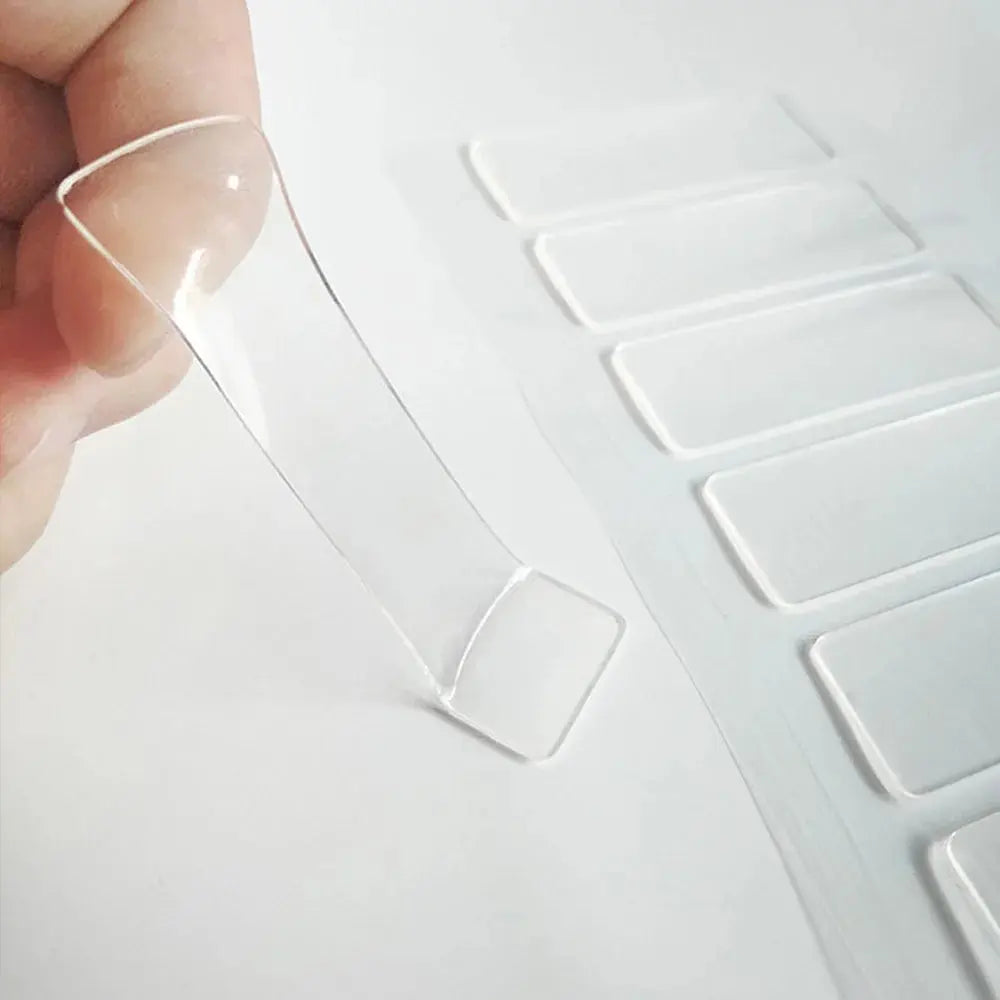 Set of 20 transparent adhesive cable clips from Smartlyo holding and organizing cables on walls or desks.